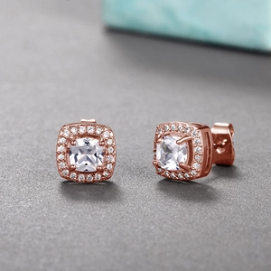 Detailed view of rose gold cushion-cut zircon stud earrings with a sparkling halo setting