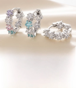 Detail view of silver star earrings with zircons and a 10mm inner diameter dimension