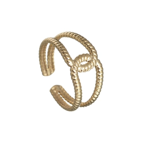 Macro detail of gold-plated double-layer rope ring with a central knot decorative element
