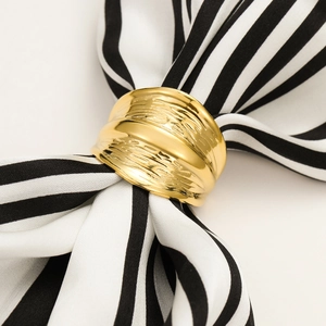 Golden textured stainless steel wide ring used as a silk scarf clip on a striped scarf