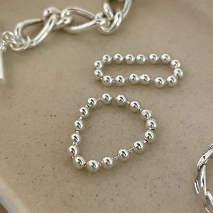 Minimalist 925 sterling silver bead ring set with high polish finish shown on ceramic