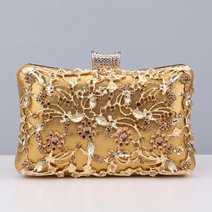 Close-up of gold evening clutch featuring intricate crystal-encrusted floral patterns