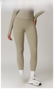 Detail of high waist camel brown yoga set showing thumbhole sleeves and matte fabric texture
