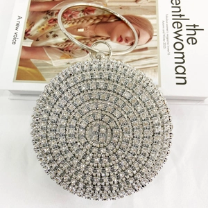 Detailed close-up of a luxury silver rhinestone evening bag with round metal handle