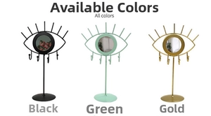 Three eye-shaped jewelry organizers in black, green, and gold with mirrors and hooks