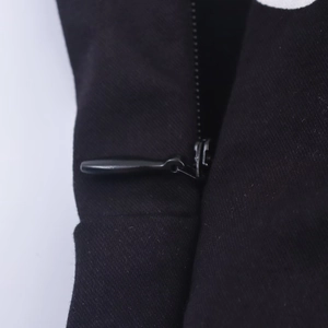 Detailed close-up showing the invisible zipper and precise seam on this black halter top