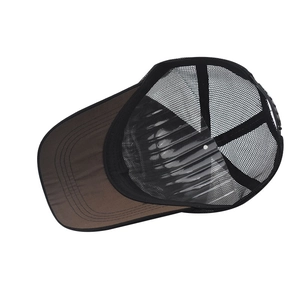 Detailed view of brown fabric brim and black mesh back with adjustable strap on a trucker hat