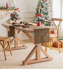 Close-up of brown woven Christmas table runner with mesh texture on wooden table