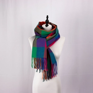 Close-up of colorful British plaid scarf with fringe tassels on a display model