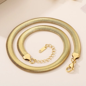 Detailed view of an 8mm golden flat snake bone chain with lobster clasp and extender