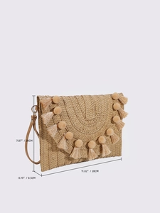 Straw envelope clutch bag with tassels and wrist strap shown in 45-degree angle view