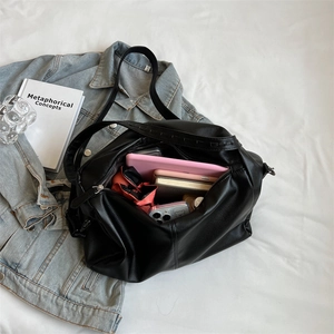 Large capacity black pebble leather tote bag showing spacious interior with zipper closure