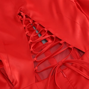 Detail of red satin dress featuring cross lacing back and hidden zipper closure