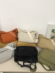 Waterproof nylon messenger bag shown in six versatile colors for students and travel