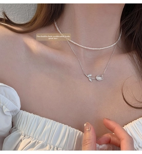 Close-up of a double-layer tulip necklace with white chalcedony and pearls on a model