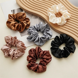 Set of 6 high-quality satin scrunchies with elegant silk luster on a wooden tray