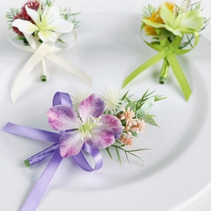 Three elegant artificial flower boutonnieres in purple, white and green for wedding suits