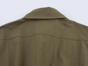 Detail of army green utility shirt collar and brushed fabric texture on shoulders