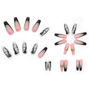 Macro shot of long gradient pink nails with golden lines and butterfly wing designs
