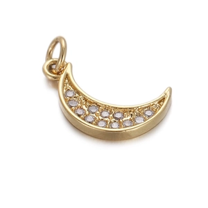 Detailed close-up of a crescent moon pendant with gold plating and sparkling crystals