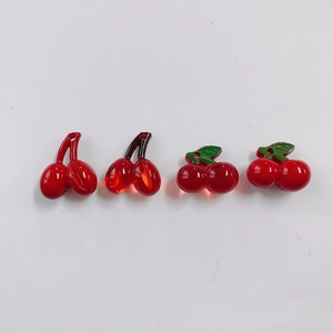 Detail view of four red acrylic cherry pendants for DIY jewelry making accessories