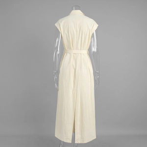 Detail of cream sleeveless dress featuring a tailored lapel collar and back slit detail