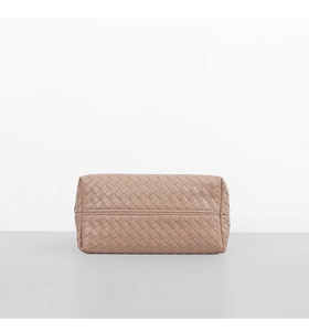 Detail of woven texture and zipper on dusty rose faux leather shoulder bag