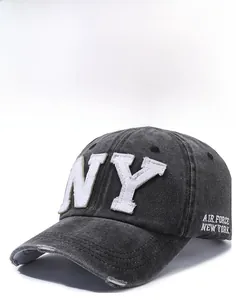 Detail of grey washed denim baseball cap with NY embroidery and distressed brim effect