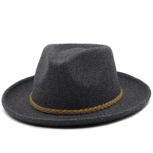 Detailed texture of grey wool fedora hat with a brown braided leather band trim