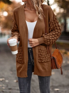Detail view of brown V-neck knit cardigan with textured knit bubble patterns on sleeves