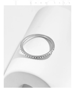 Macro shot of S925 sterling silver band ring with sparkling D-color moissanite accents