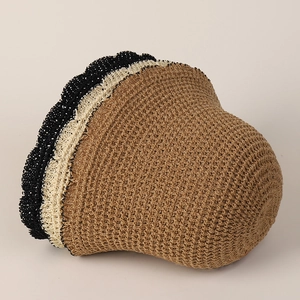 Detailed view of the hollow-out knit pattern and wavy color-block edge of the sun hat