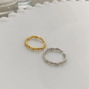 Detail showing irregular textured bubble pattern on gold and silver S925 rings