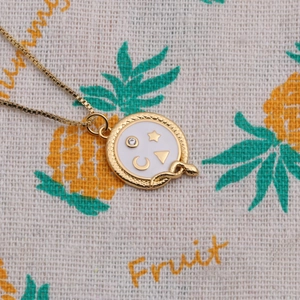 Golden snake pendant necklace with celestial star and moon motifs on round zircon charm