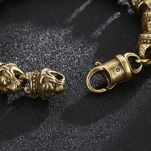 Detail of vintage bronze lion head bracelet with textured metal and lobster clasp