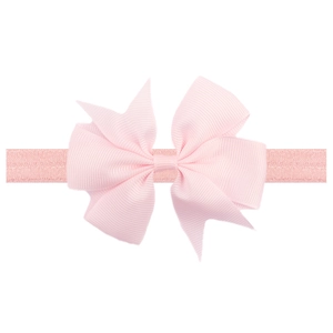 Pink grosgrain ribbon bow headband for babies with elastic fabric band on white background