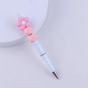 Detail of DIY white beaded pen with pink silicone flower and geometric decorative beads