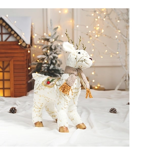 Detail of plush white reindeer figurine with gold antlers and festive checkered scarf