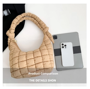 Macro view of beige quilted puffy shoulder bag showing knot handle and large capacity