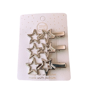 Set of 3 silver Y2K metallic star-shaped hair clips displayed on a white product card