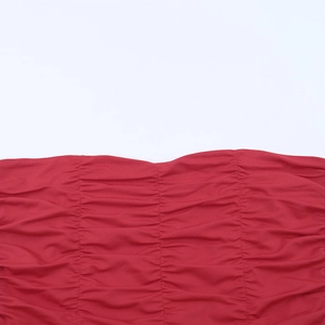Detailed macro shot of red dress fabric featuring vertical ruching and fine stitching