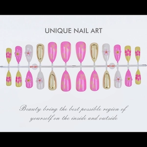 Detail of 3D flower press-on nails with almond shape and golden mirror edge finish