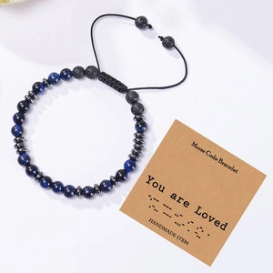 Detail of adjustable Morse code bracelet with blue tiger eye and black lava stones