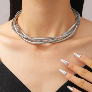 Detail shot of multi-layer silver braided spring necklace worn by a fashion model