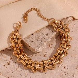 Detail view of 18K gold-plated triple strand woven bracelet with lobster clasp and chain