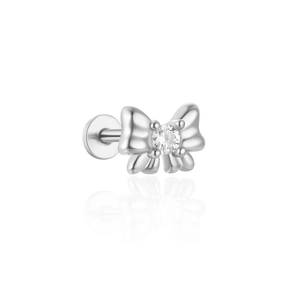 Macro shot of a silver bow-shaped cartilage stud with a round cubic zirconia stone