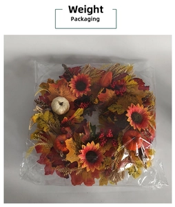 Detail view of autumn harvest wreath with pumpkins and maple leaves in plastic packaging