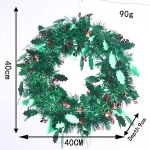 Detail view of 40cm Christmas tinsel wreath with red berries and green leaf accents