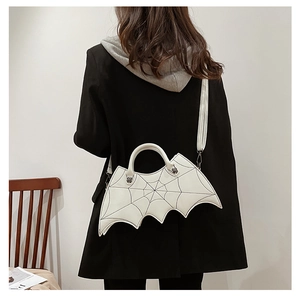 Detailed back view of a white PU leather bat wing bag with black spider web embroidery