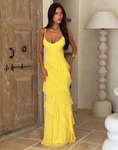 Detail of yellow backless maxi dress with delicate straps and ruffled side slit design
